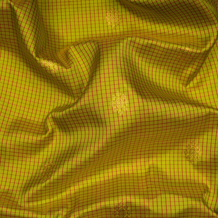 Lime green Gadwal silk saree with red check lines and small butta body, red zari border with rudraksh and mango motifs, plain red blouse.