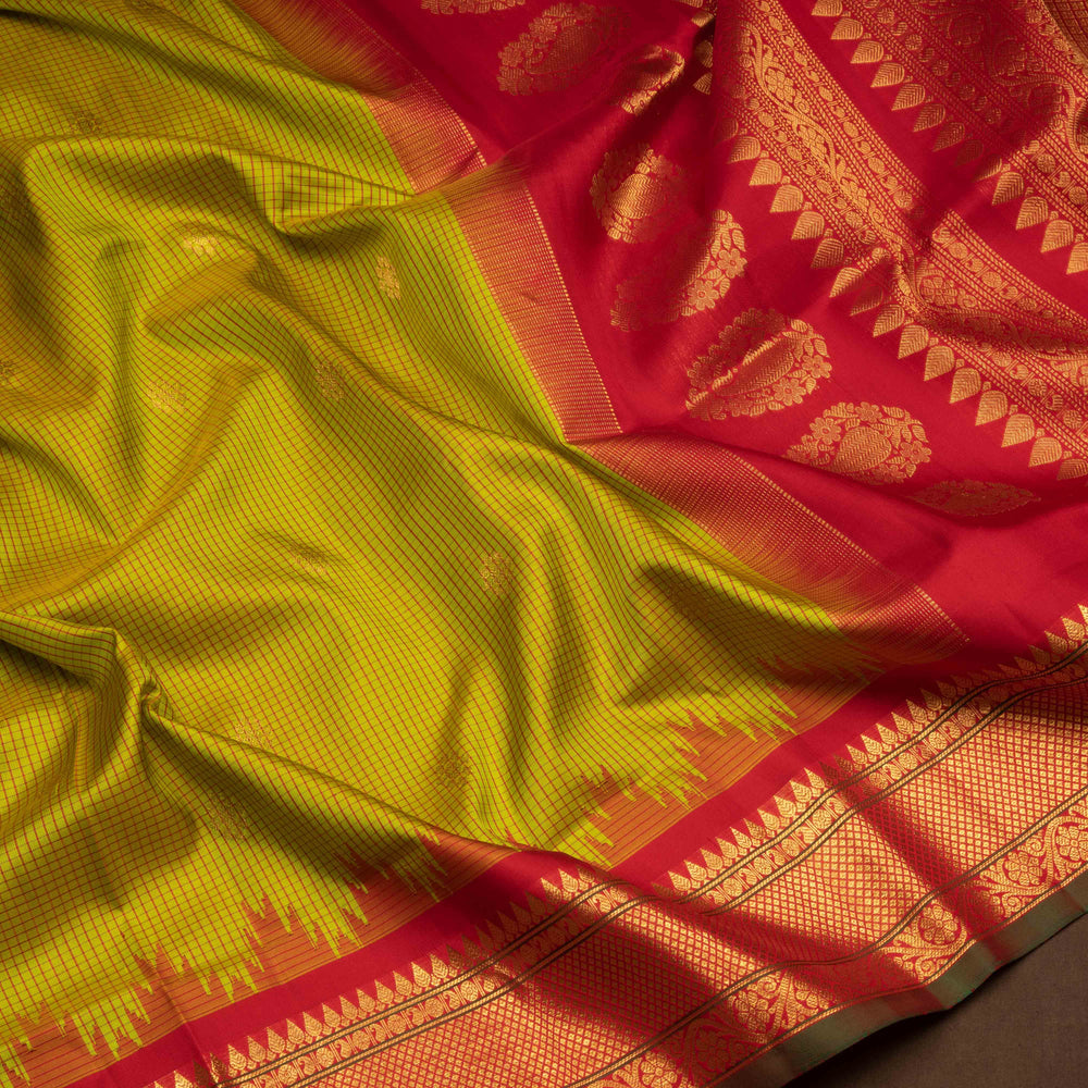 Lime green Gadwal silk saree with red check lines and small butta body, red zari border with rudraksh and mango motifs, plain red blouse.