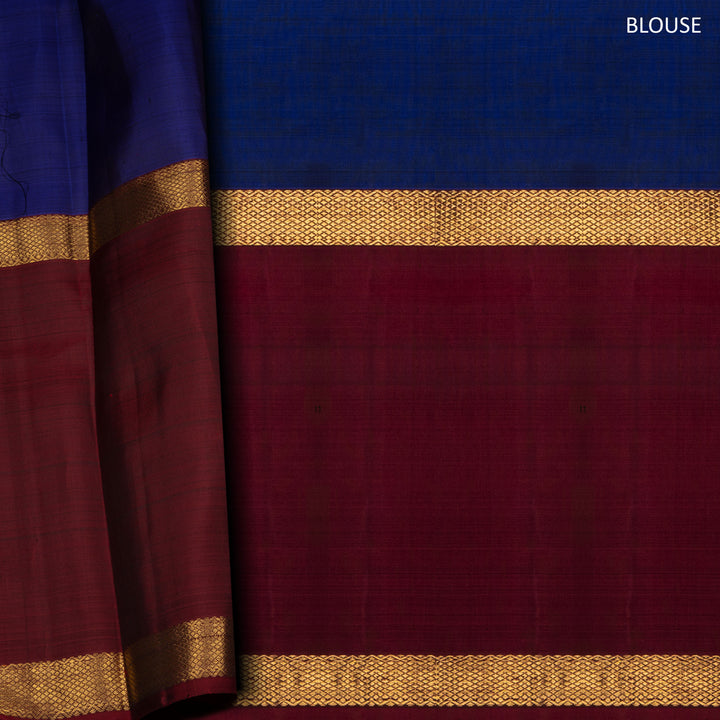 Blue Kanchipuram silk saree with two different gold zari borders featuring diamond and veldhari motifs and zari-lined pallu.