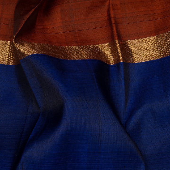 Blue Kanchipuram silk saree with two different gold zari borders featuring diamond and veldhari motifs and zari-lined pallu.