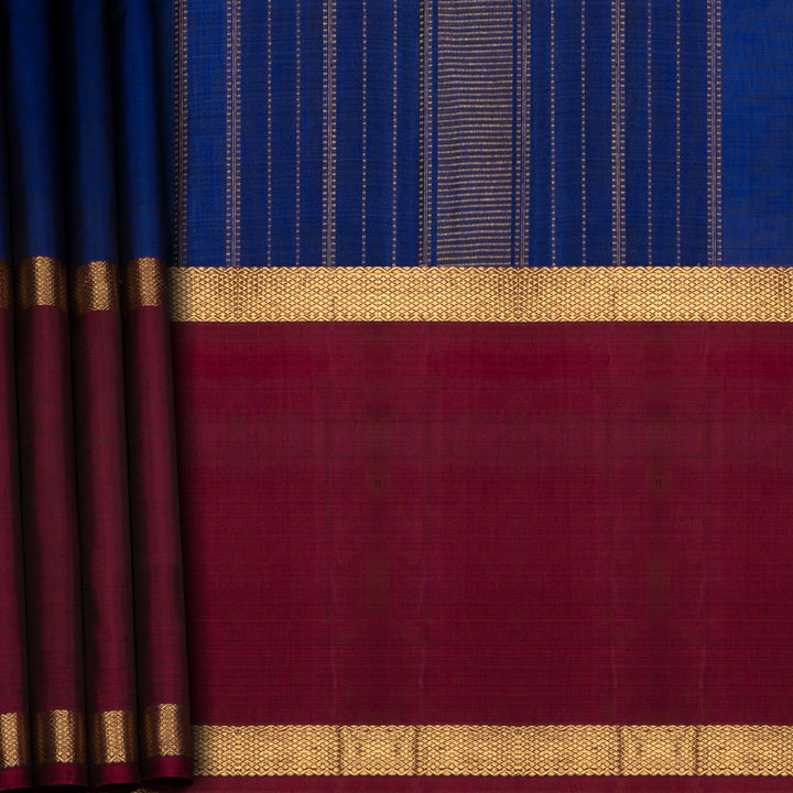 Blue Kanchipuram silk saree with two different gold zari borders featuring diamond and veldhari motifs and zari-lined pallu.