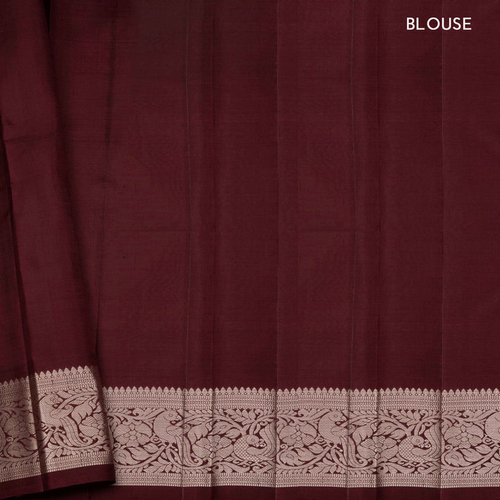 Peach handwoven Kanjivaram silk saree with horizontal stripes and chakram buttas, maroon border with parrot and floral motifs, and matching maroon blouse.