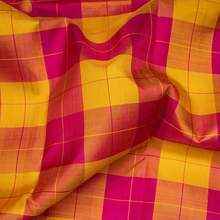 Multicolor handwoven Kanjivaram silk saree with checkered body, korvai thazampoo motifs, green rettapet border, and temple design pallu, paired with green blouse.