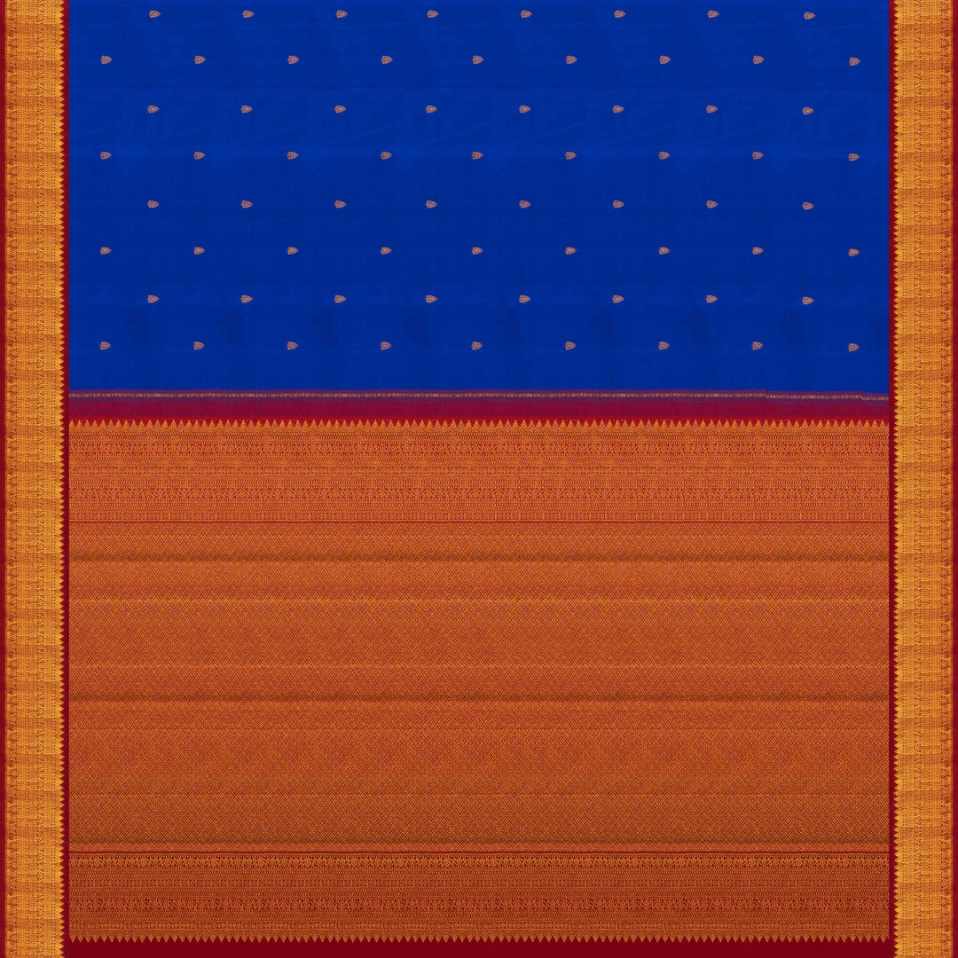 Blue handwoven Kanjivaram silk saree with gold buttas, red border with chevron and floral designs, and matching pallu, paired with plain red blouse.