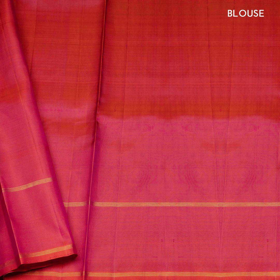 Green handwoven Kanjivaram silk saree with vertical gold dash buttas, rettapet border, and peach-pink dual tone pallu with zari motifs, paired with peach blouse.