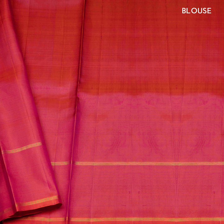 Green handwoven Kanjivaram silk saree with vertical gold dash buttas, rettapet border, and peach-pink dual tone pallu with zari motifs, paired with peach blouse.