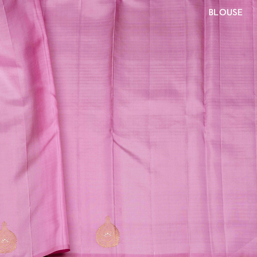 Beige handwoven Kanjivaram silk saree with self design and gold zari floral motifs, lavender border and pallu with chevron and floral patterns, paired with lavender blouse.