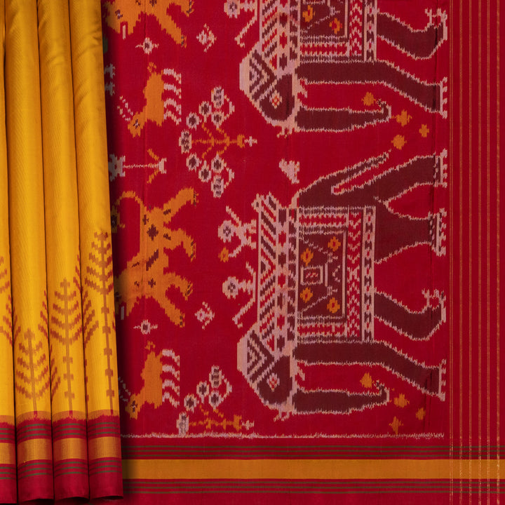 Yellow Ikat silk saree with red border accents, green and yellow border lines and red pallu with animal and human motifs, paired with red ikat blouse.