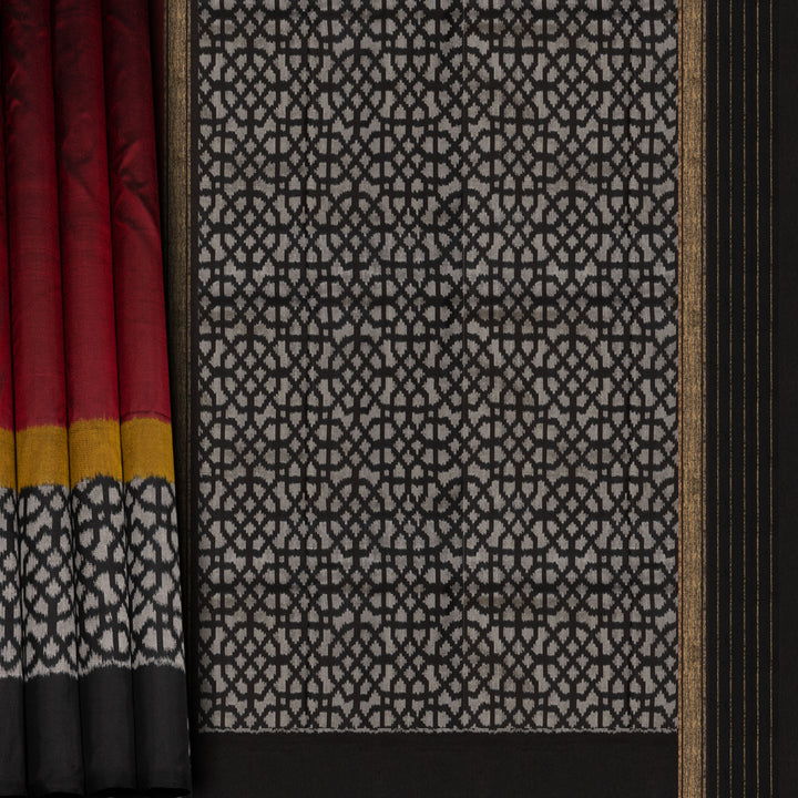 Red Pochampally Ikat silk saree with yellow ikat border, black panel, and black and white ikat pallu, paired with plain black blouse.