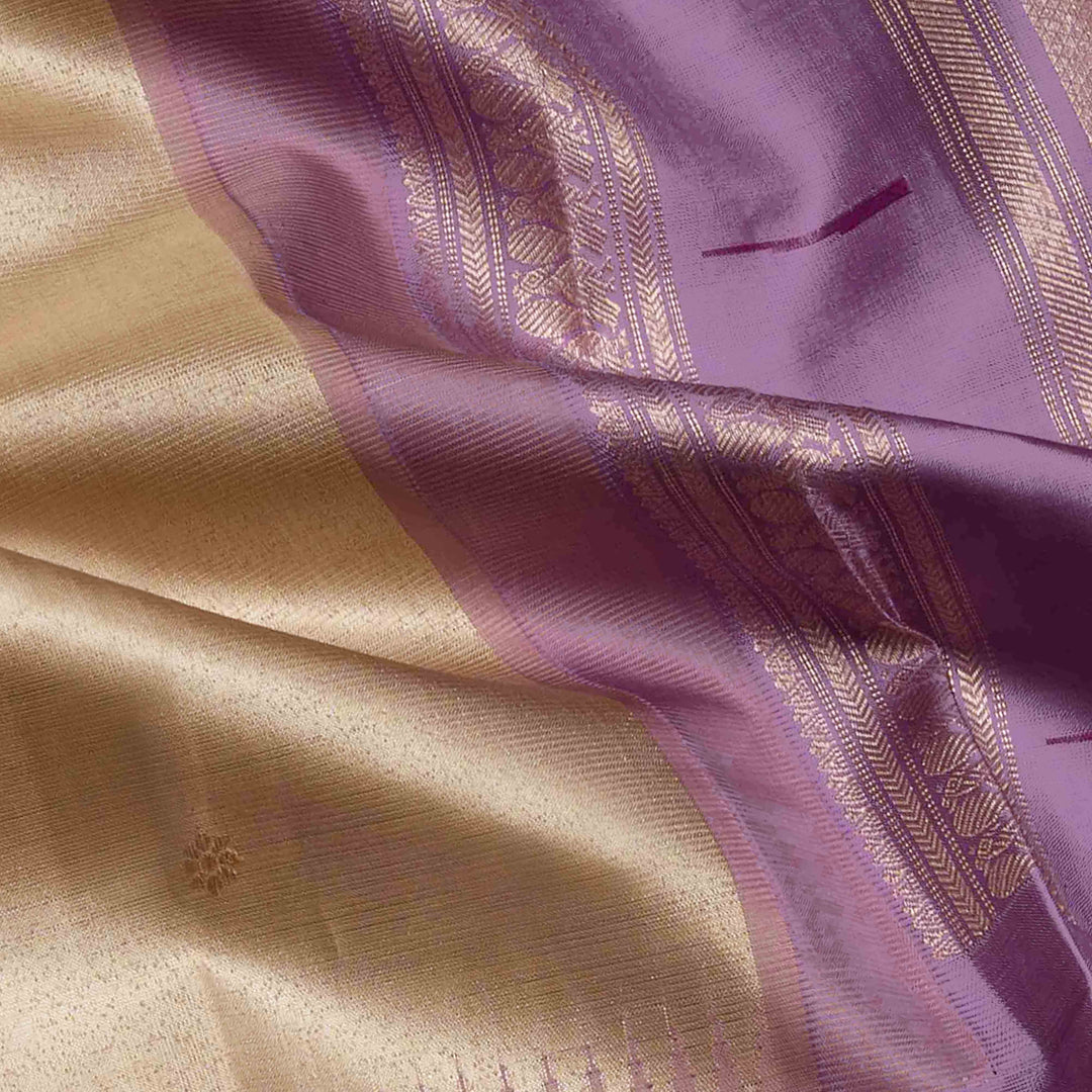Cream Kanjivaram silk saree with tissue body, silver zari floral butta, lavender Paithani border and annam design pallu with matching blouse