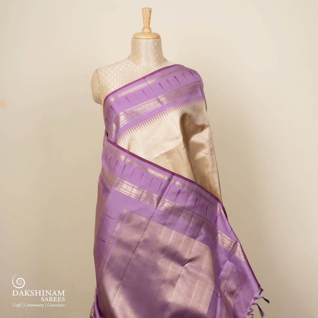 Cream Kanjivaram silk saree with tissue body, silver zari floral butta, lavender Paithani border and annam design pallu with matching blouse