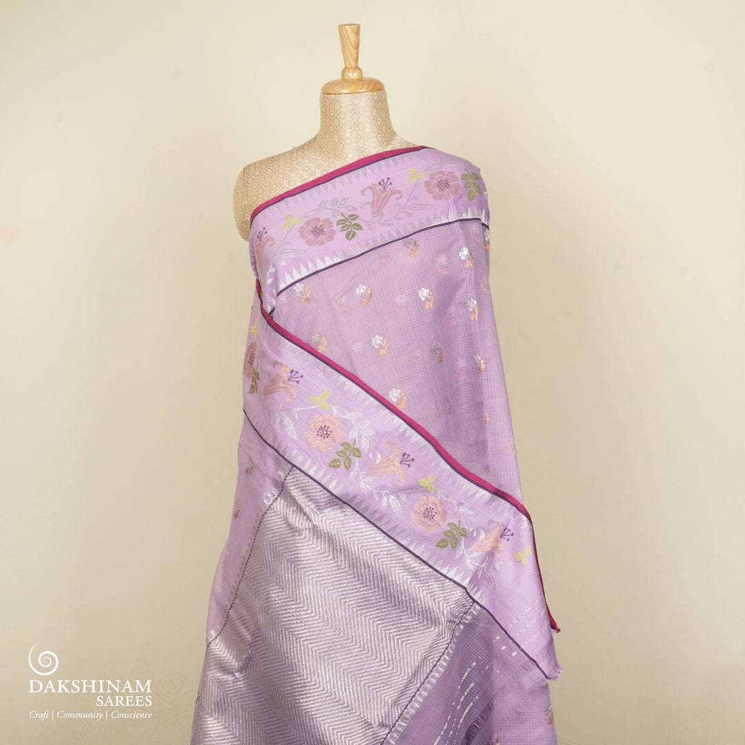 Purple Kota doria silk saree with silver zari floral butta, chevron pallu and floral zari border with yellow blouse