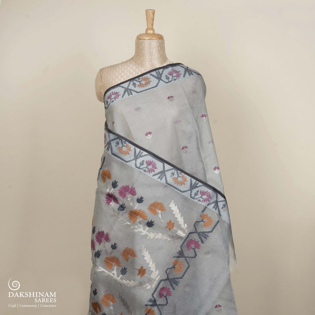 Grey Kota doria silk saree with silver zari floral butta, floral pallu and vine border with matching blouse