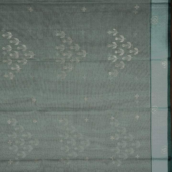 Moss green Kota doria silk saree with silver zari floral motifs, monotone border and pallu with silk thread flowers and chevron blouse