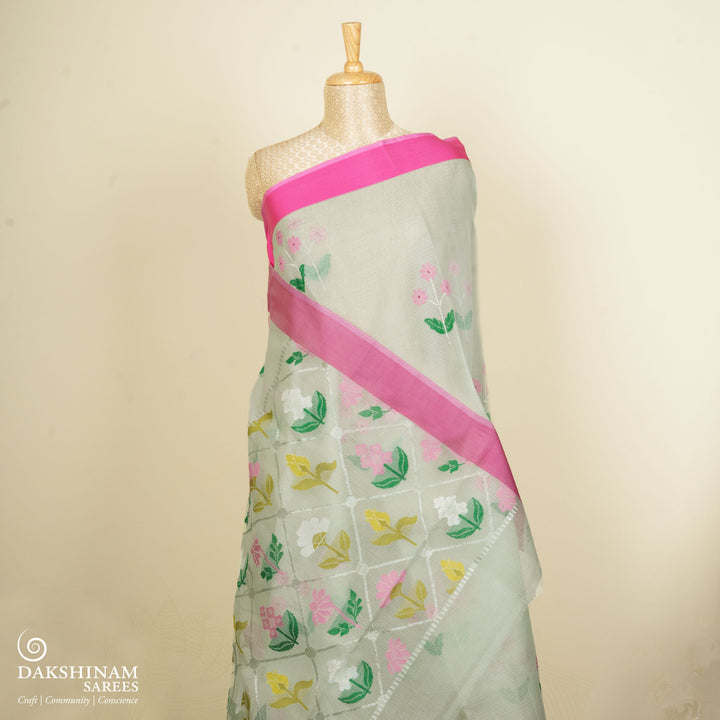 Light green Kota doria silk saree with silver zari floral motifs, silk thread flowers, diamond pallu and pink border with matching blouse