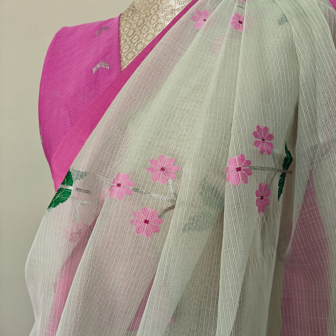 Light green Kota doria silk saree with silver zari floral motifs, silk thread flowers, diamond pallu and pink border with matching blouse