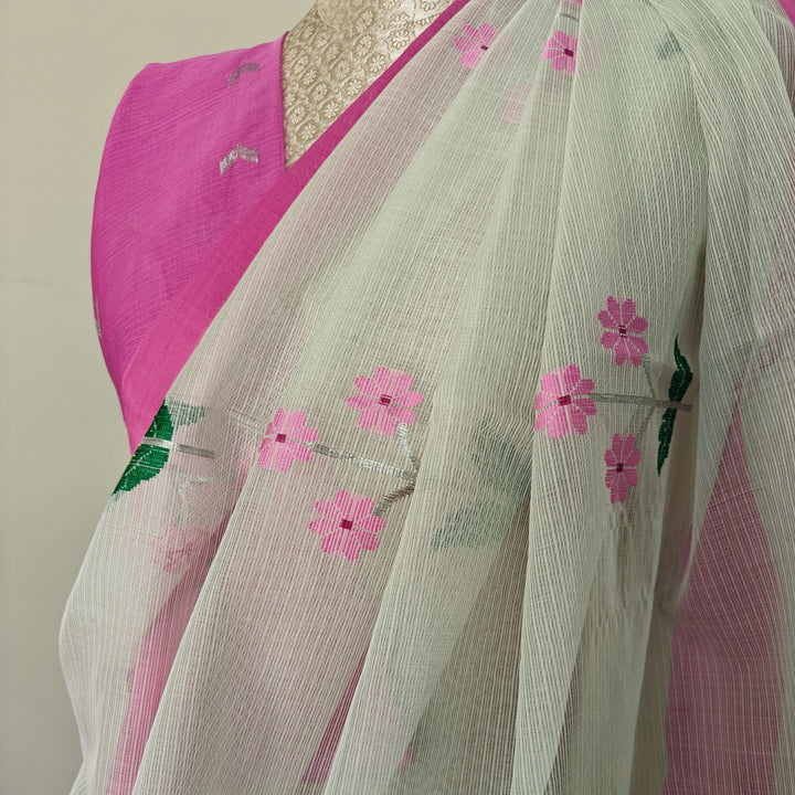 Light green Kota doria silk saree with silver zari floral motifs, silk thread flowers, diamond pallu and pink border with matching blouse