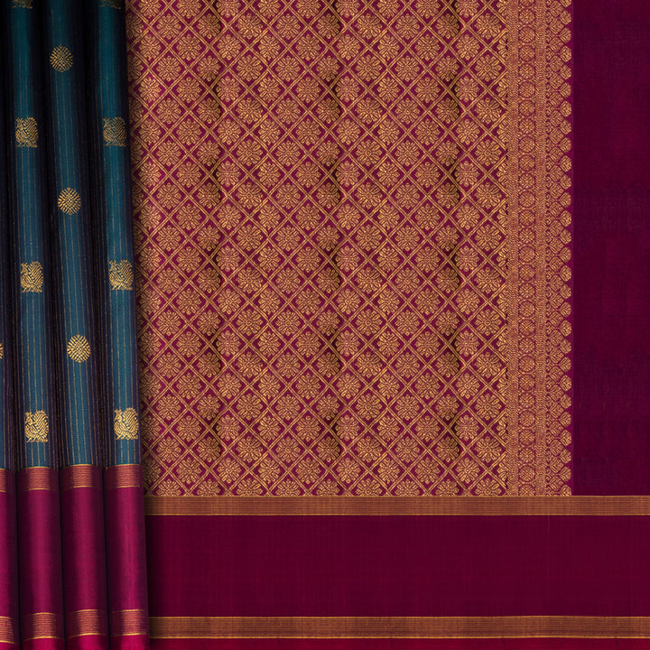 Peacock green Kanjivaram silk saree with gold zari stripes, annam and chakram butta, magenta rettapet border and detailed pallu with matching blouse