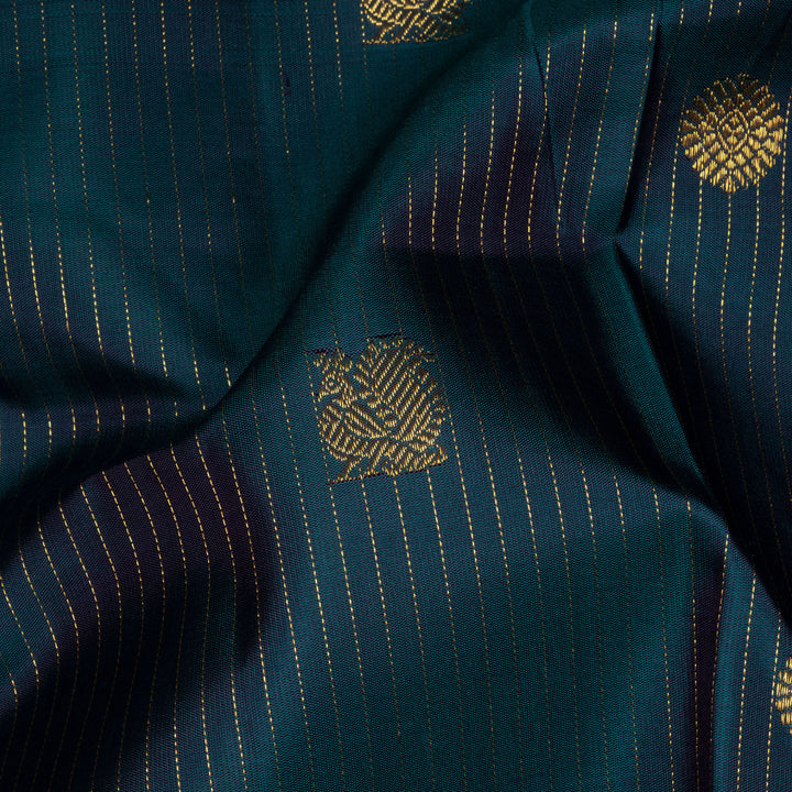 Peacock green Kanjivaram silk saree with gold zari stripes, annam and chakram butta, magenta rettapet border and detailed pallu with matching blouse