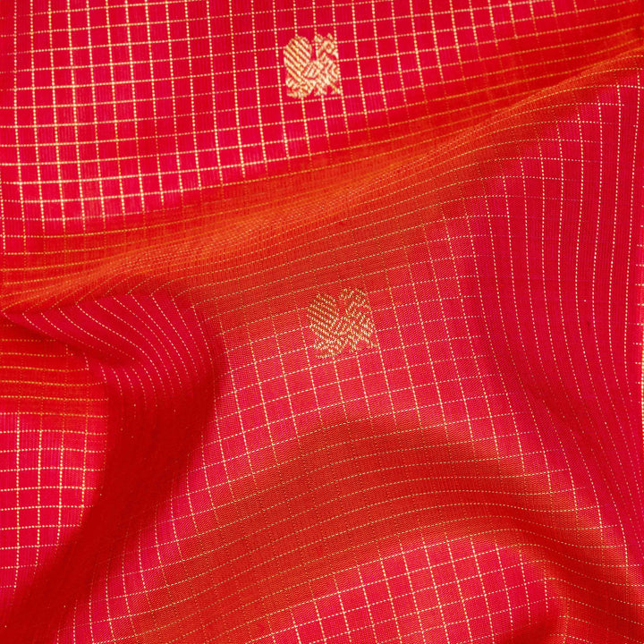 Orange Kanjivaram silk saree with pink-tone vairoosi checks, annam and vaira mookuthi butta, green pallu and matching blouse