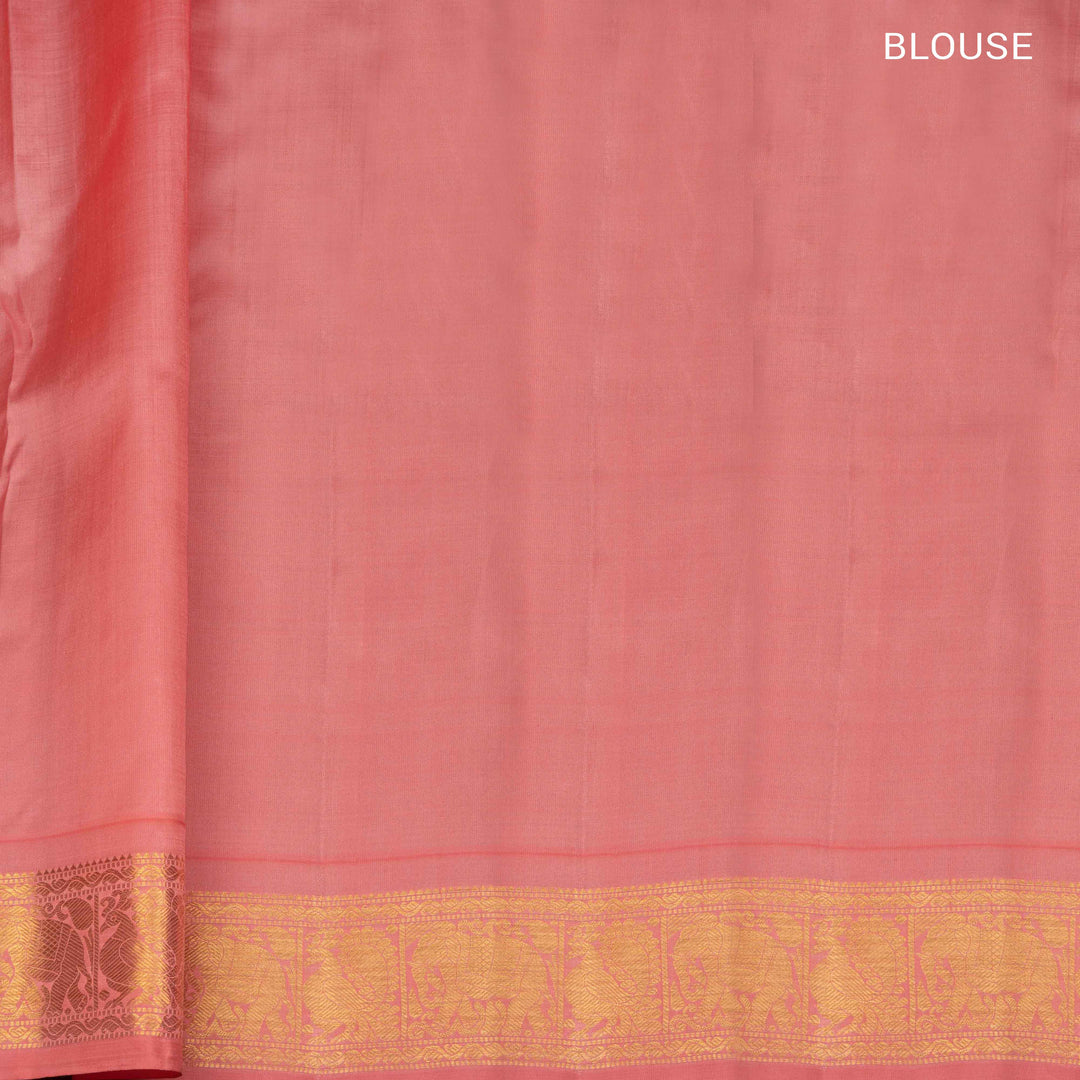 Pink Kanjivaram silk saree with gold zari mango butta, light pink pallu with peacock and elephant motifs, and matching blouse