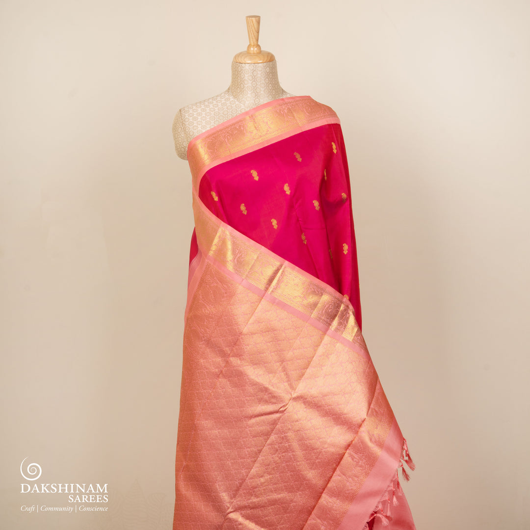 Pink Kanjivaram silk saree with gold zari mango butta, light pink pallu with peacock and elephant motifs, and matching blouse