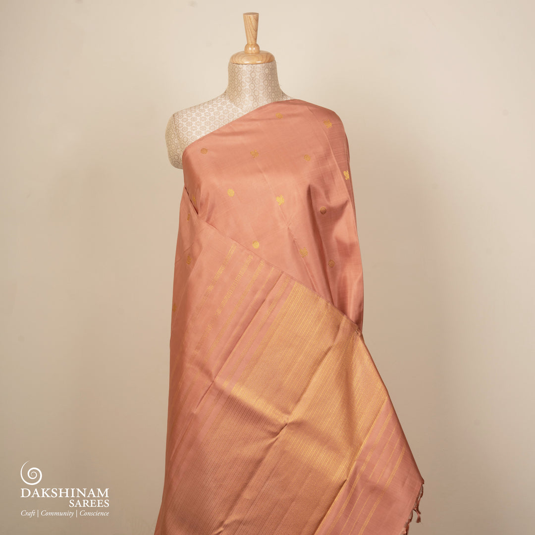 Beige peach Kanjivaram silk saree with annam and chakram butta, gold zari lined pallu and matching monotone blouse