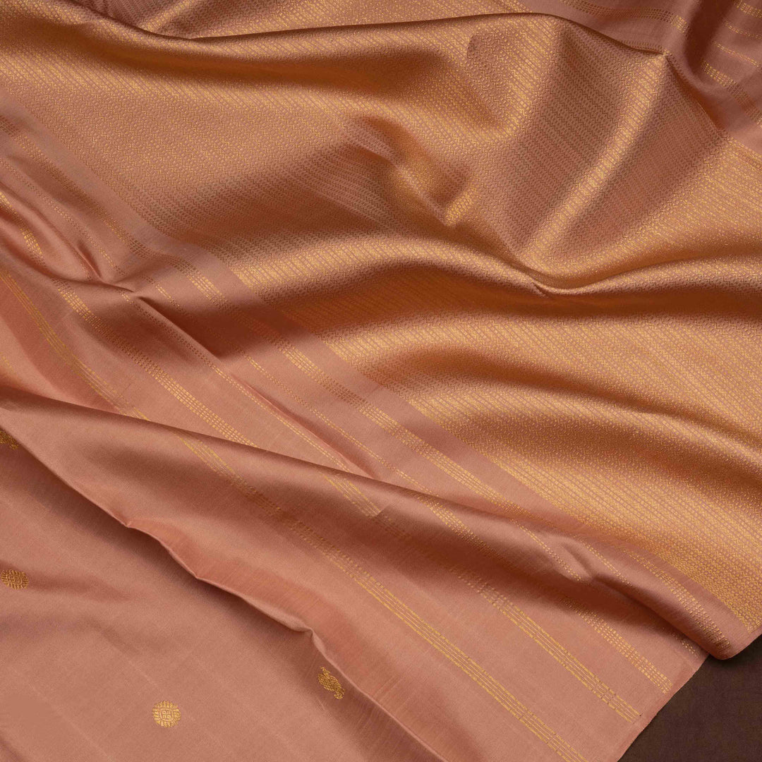 Beige peach Kanjivaram silk saree with annam and chakram butta, gold zari lined pallu and matching monotone blouse