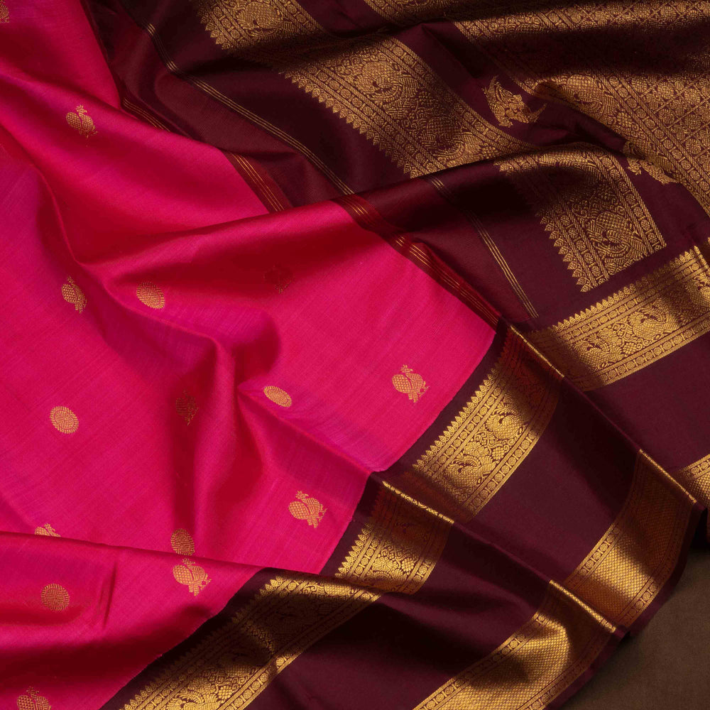 Pink Kanjivaram silk saree with annam and chakram butta, maroon rettapet border and rich traditional pallu with matching blouse