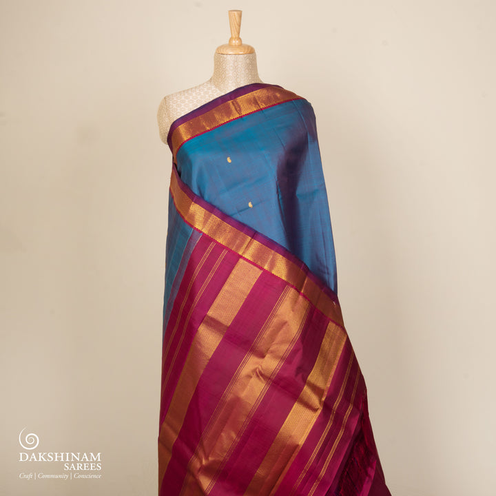 Blue Kanjivaram silk saree with mango butta, violet getti border and chevron diamond panel pallu with contrast blouse