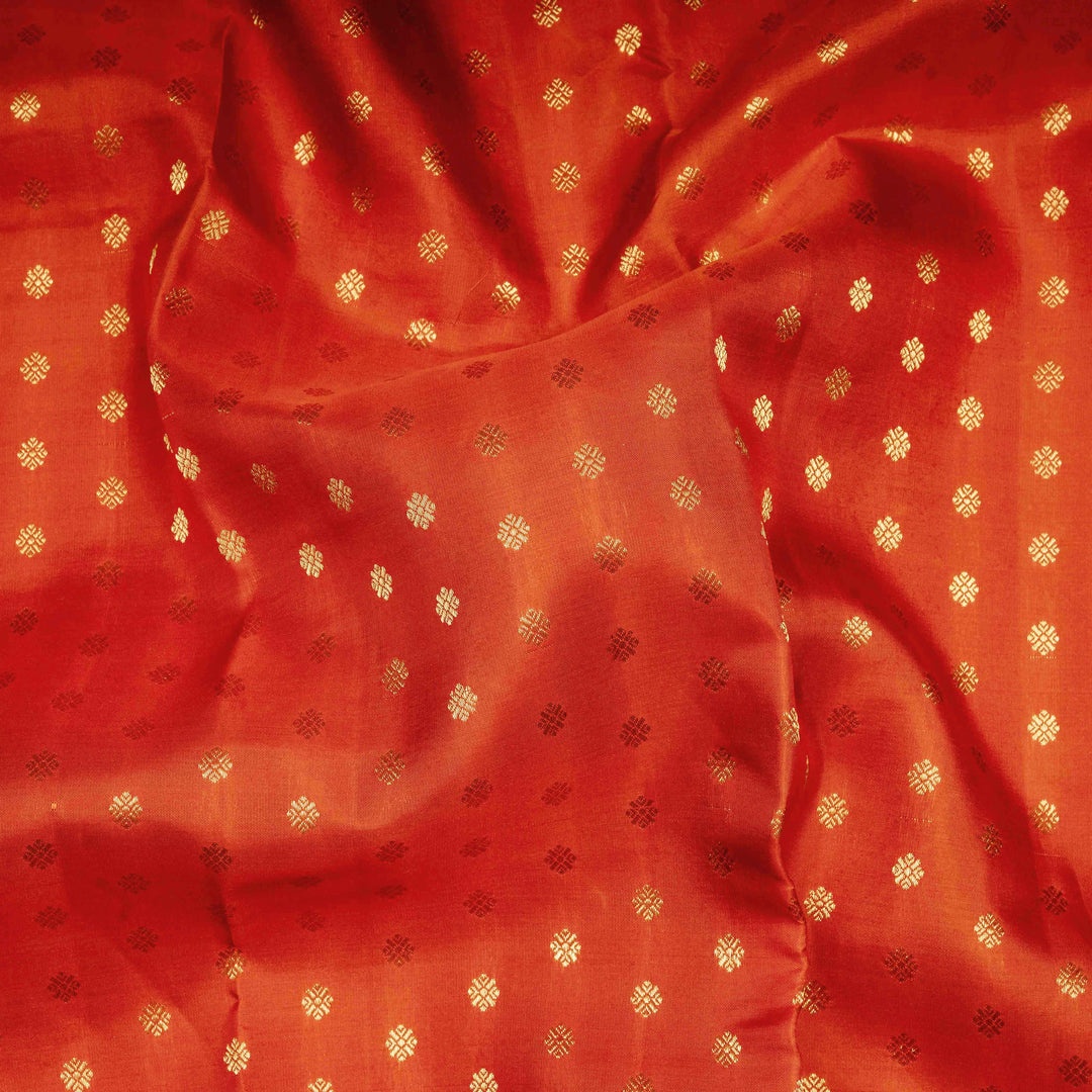 Orange Kanjivaram silk saree with allover diamond butta, turning border and rich pallu with rudraksham, chevron lines and retta killi motifs