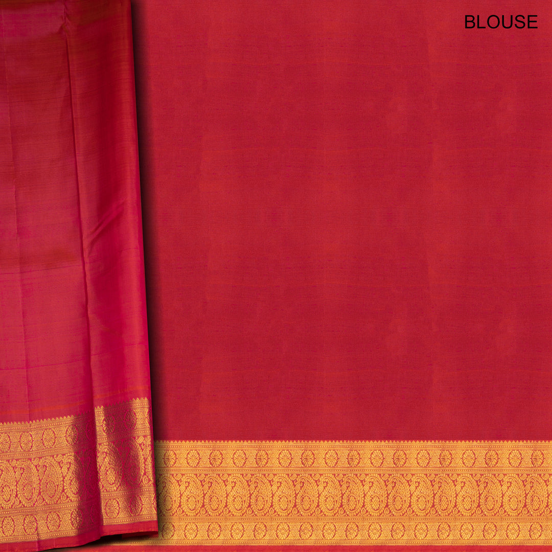 Yellow Kanjivaram silk saree with mayil buttas, pink korvai border featuring chakram and mango motifs, paired with plain pink blouse.