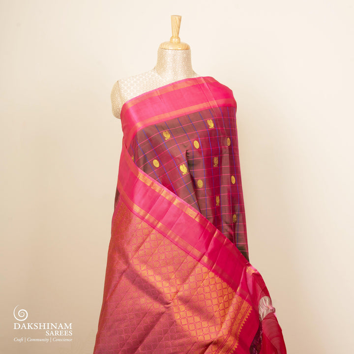 Magenta dual-tone Kanjivaram silk saree with pink border, chakram and annam motifs, and gold zari work