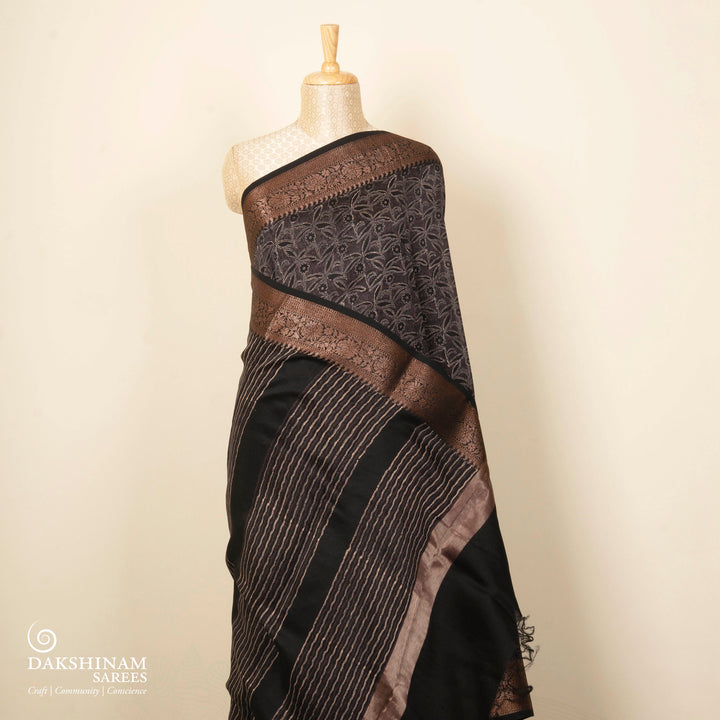 Black Chanderi silk cotton saree with white floral print, gold zari border and striped pallu