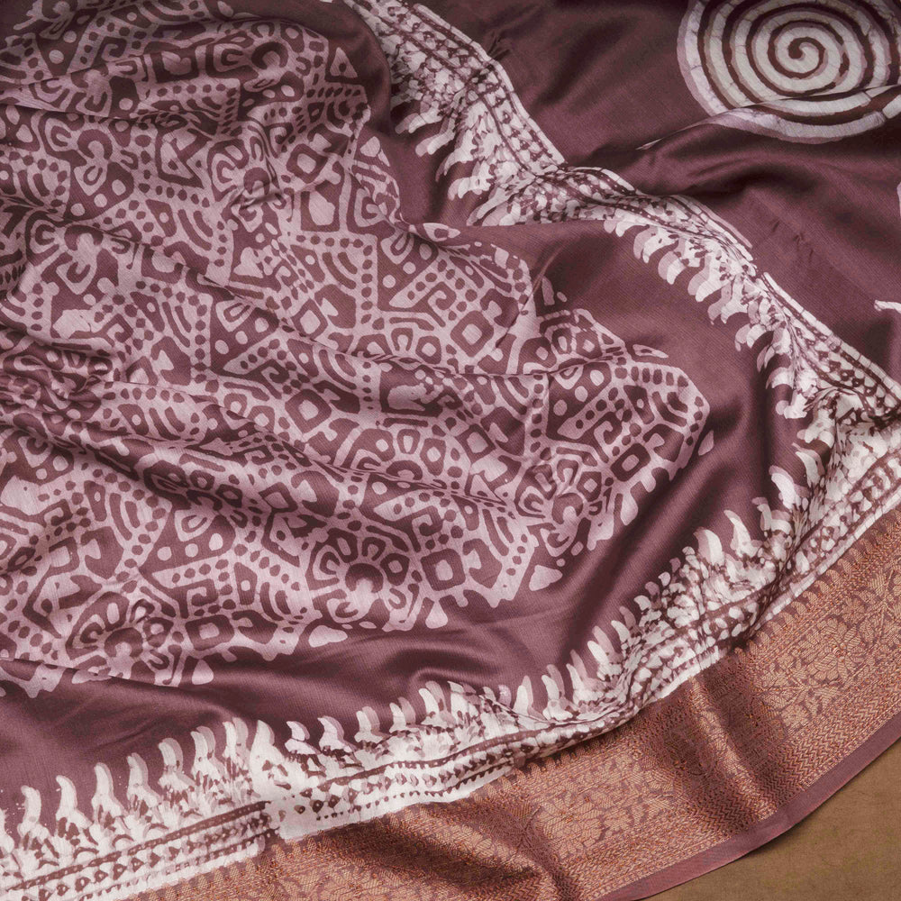 Brown handwoven silk cotton saree with batik design, gold zari floral border and artistic pallu