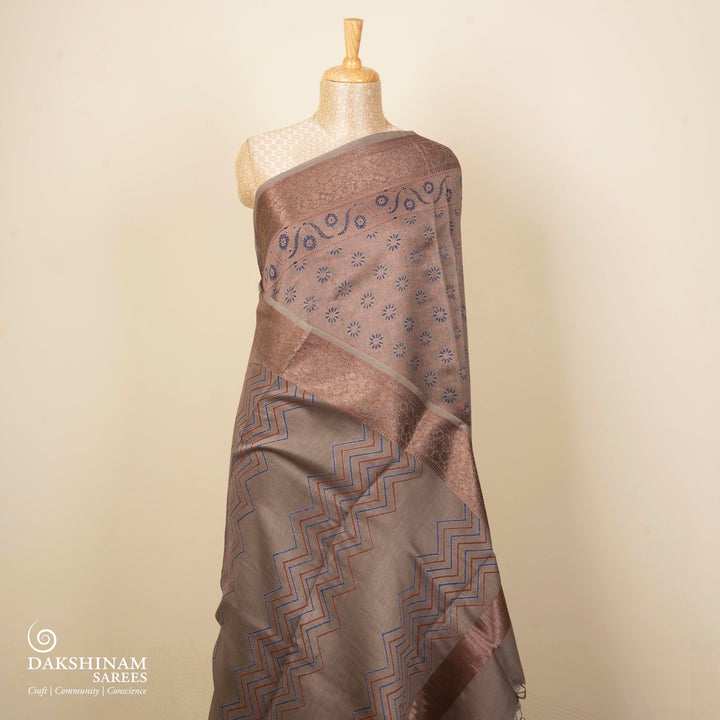 Grey Chanderi silk cotton saree with blue floral print, red diamond block print and copper zari border