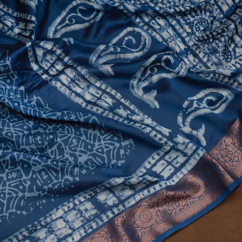 Blue Chanderi silk cotton saree with white batik print, copper zari floral border and batik mango pallu