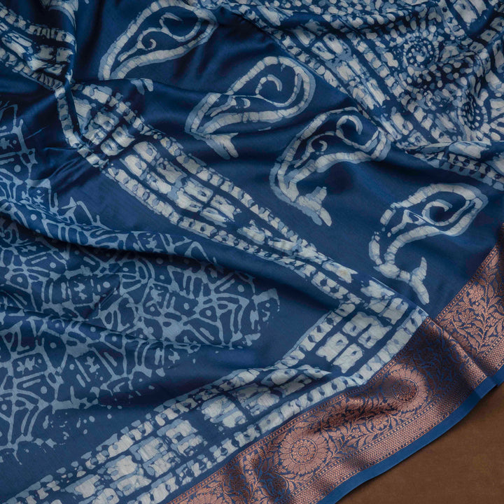 Blue Chanderi silk cotton saree with white batik print, copper zari floral border and batik mango pallu
