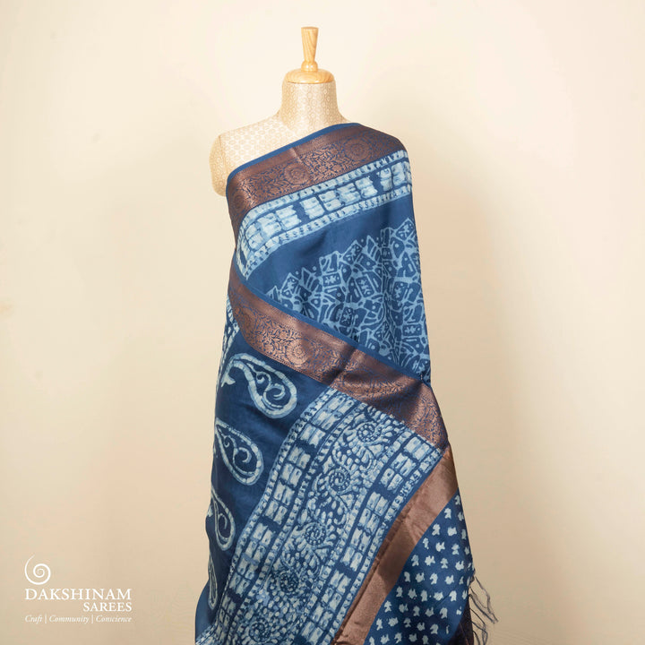 Blue Chanderi silk cotton saree with white batik print, copper zari floral border and batik mango pallu