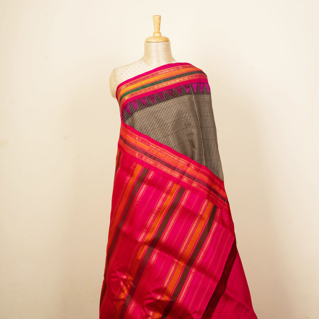 Black and white Gadwal cotton saree with multicolor Korvai border and pink silk pallu