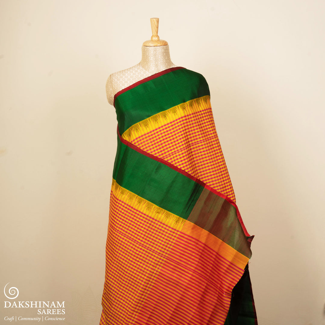 Yellow and pink checked Gadwal cotton saree with green Korvai temple border and striped pallu