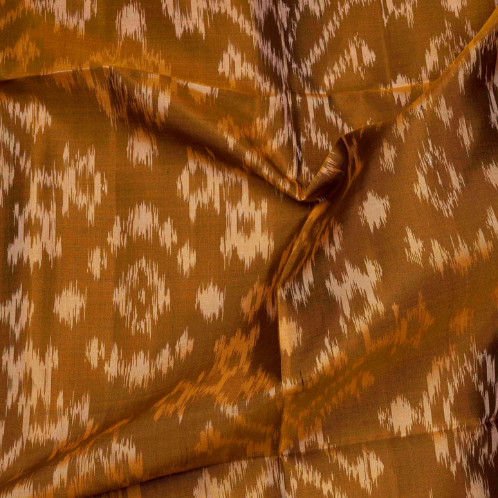 Mustard handwoven Ikat soft silk saree with white Ikat motifs and matching border