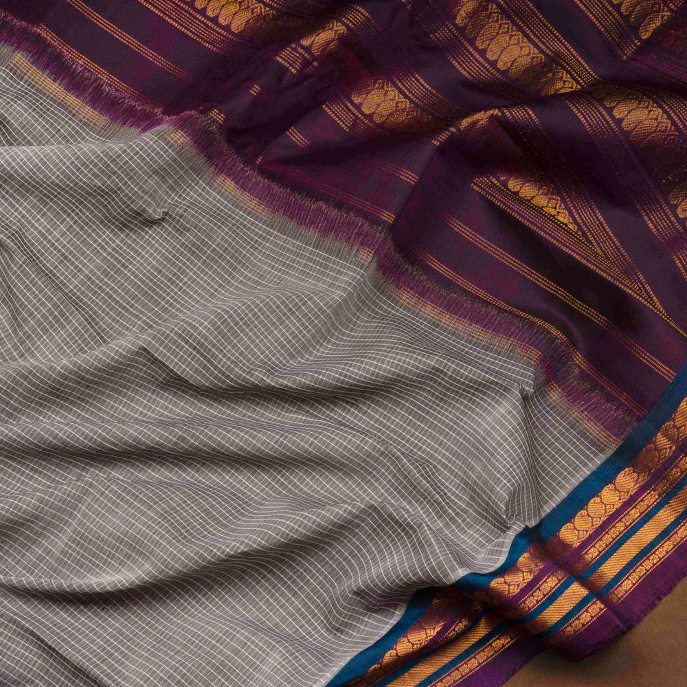 Grey Gadwal cotton saree with white checks, peacock green silk border, gold zari mango motifs and violet silk pallu