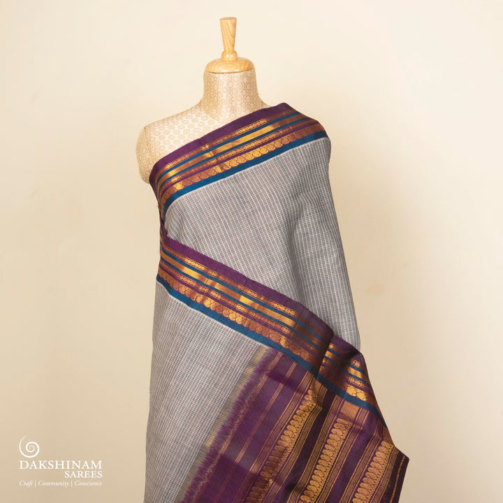 Grey Gadwal cotton saree with white checks, peacock green silk border, gold zari mango motifs and violet silk pallu