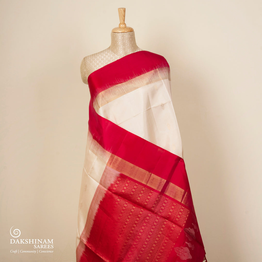 White handwoven soft silk saree with diamond motifs, red gold zari border and red pallu