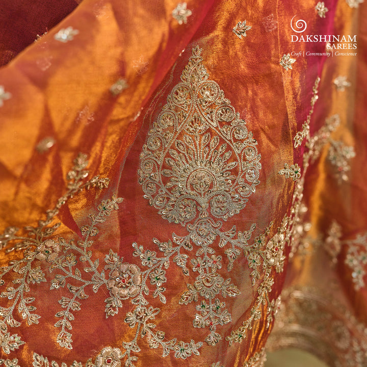 Orange embroidered tissue organza silk saree with small leaf zardozi buttas, ornate embroidered border and embroidered blouse.