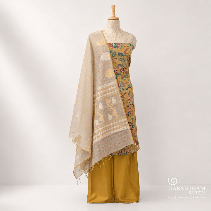Premium mustard pure cotton 3-piece suit set featuring elegant floral prints with vertical Kantha stitch detailing and hand embroidery on the top. Paired with a plain mustard bottom and a contrasting grey dupatta, this daily wear ethnic outfit offers comfort with timeless style.