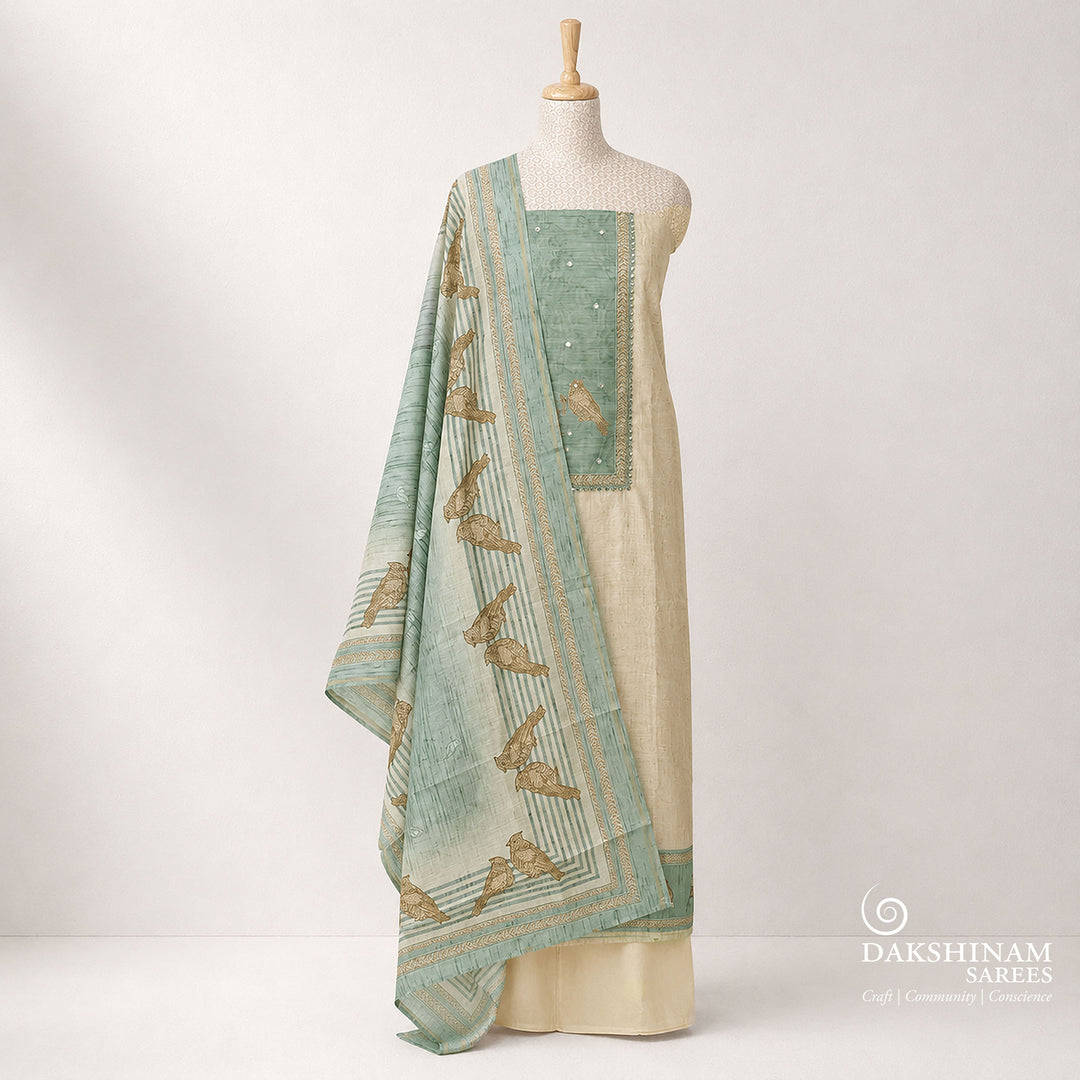 Premium beige and light blue pure cotton 3-piece suit set featuring elegant bird prints, chevron line patterns, and detailed applique work on the top. Paired with a plain beige bottom and a stylish bird printed light blue dupatta for a graceful ethnic look.