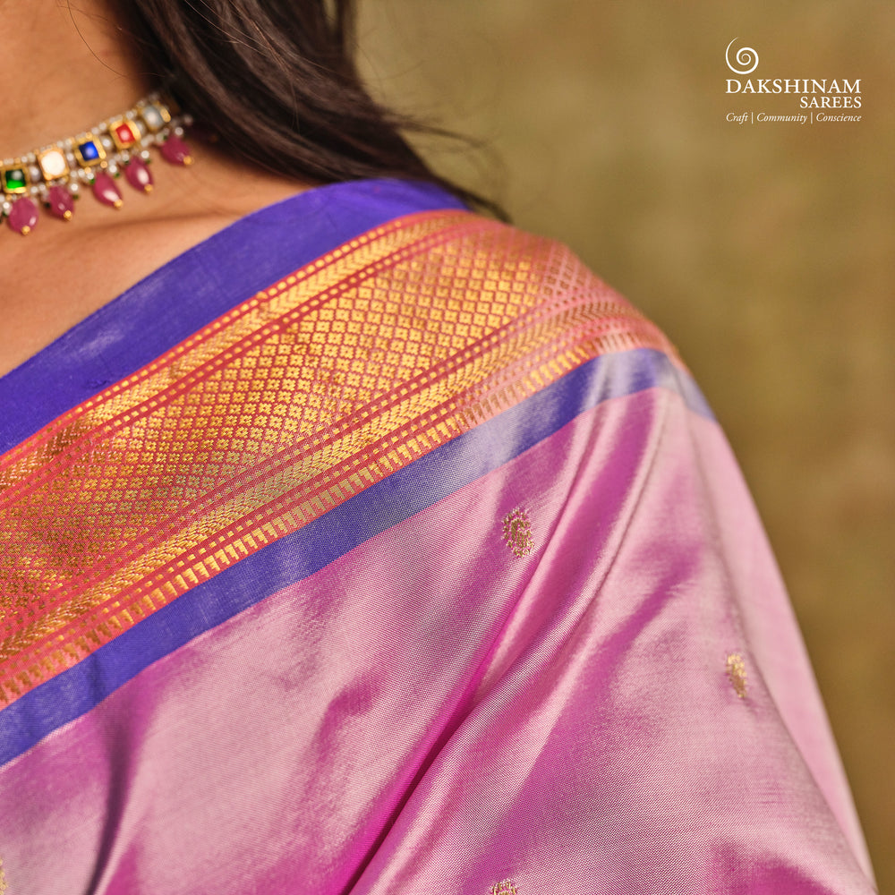 Lavender Paithani silk saree with gold zari paisley buttas, blue selvedge border with mayil motifs and traditional peacock pallu.