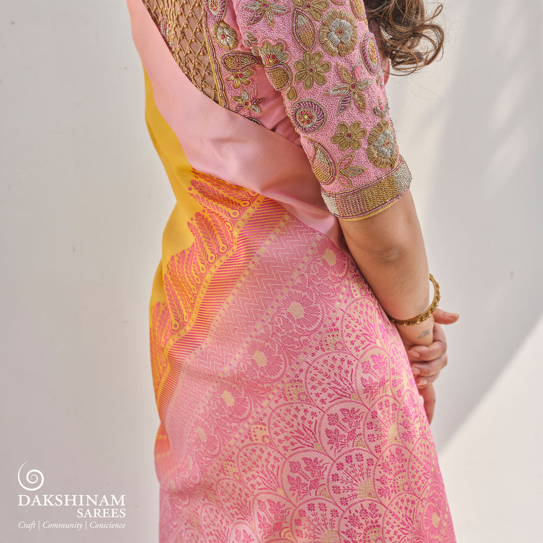 Yellow soft silk saree with self textured body and baby pink pallu with floral vine and lotus zari design